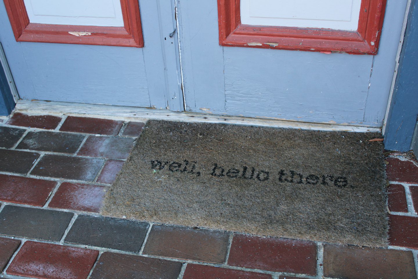 Well, hello there doormat in front of light blue doors.