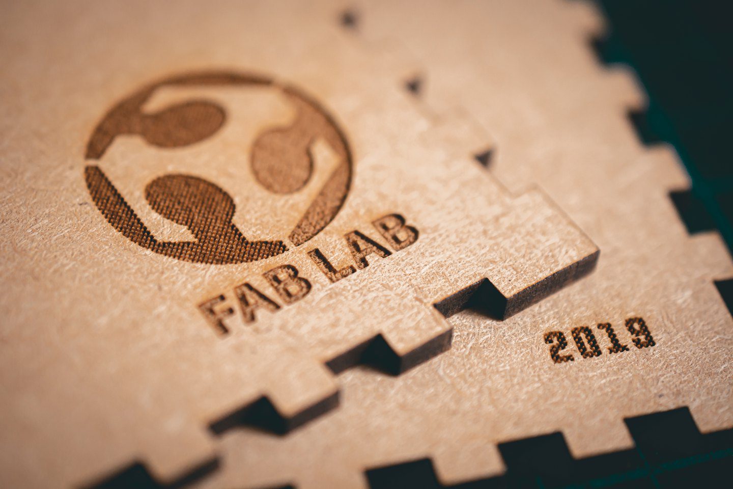 Laser engraved wood sign with FAB LAB text and logo.